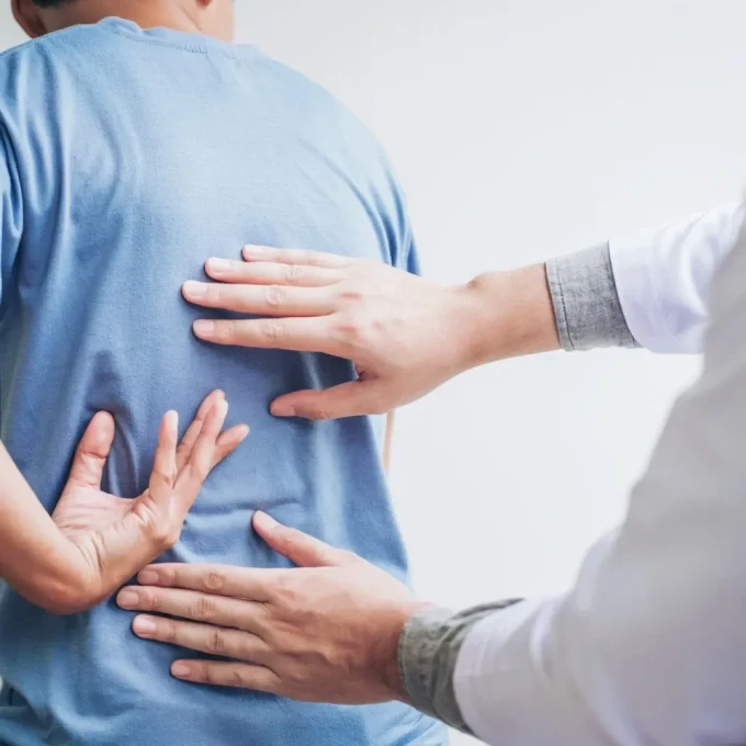 Spine doctor evaluating patient's back