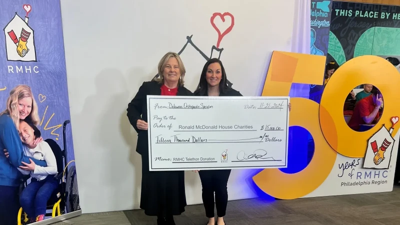 DOS employees presenting a large check donation to charity