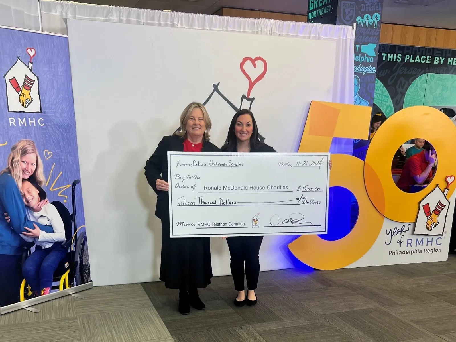 DOS employees presenting a charitable contribution large check