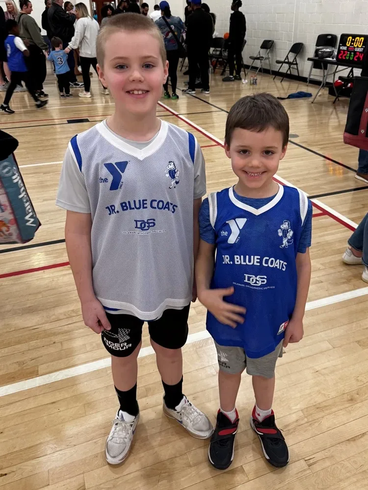 Young boys posing for photo at charity basketball event