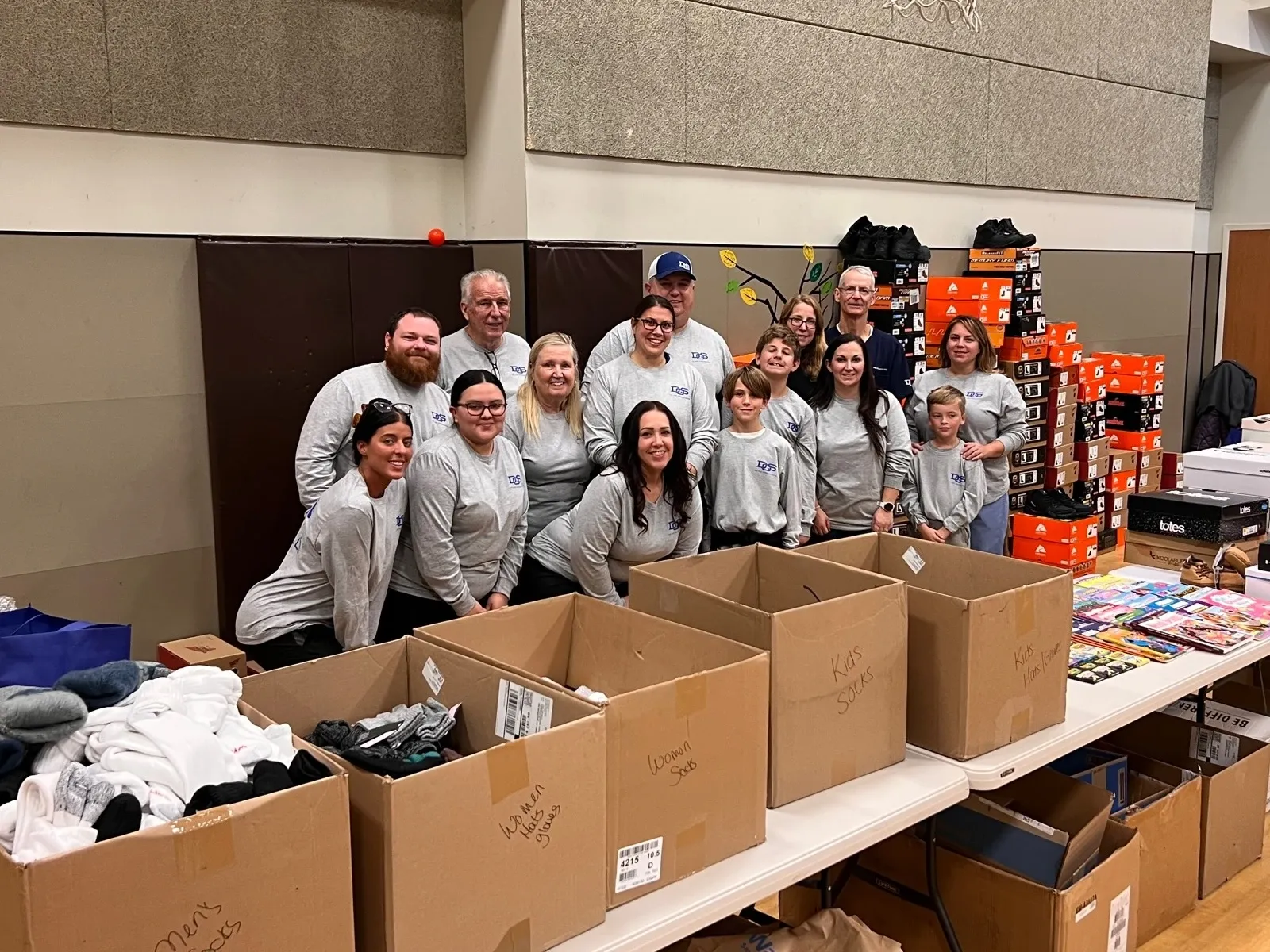 Group of DOS volunteers packaging socks for charitable donation