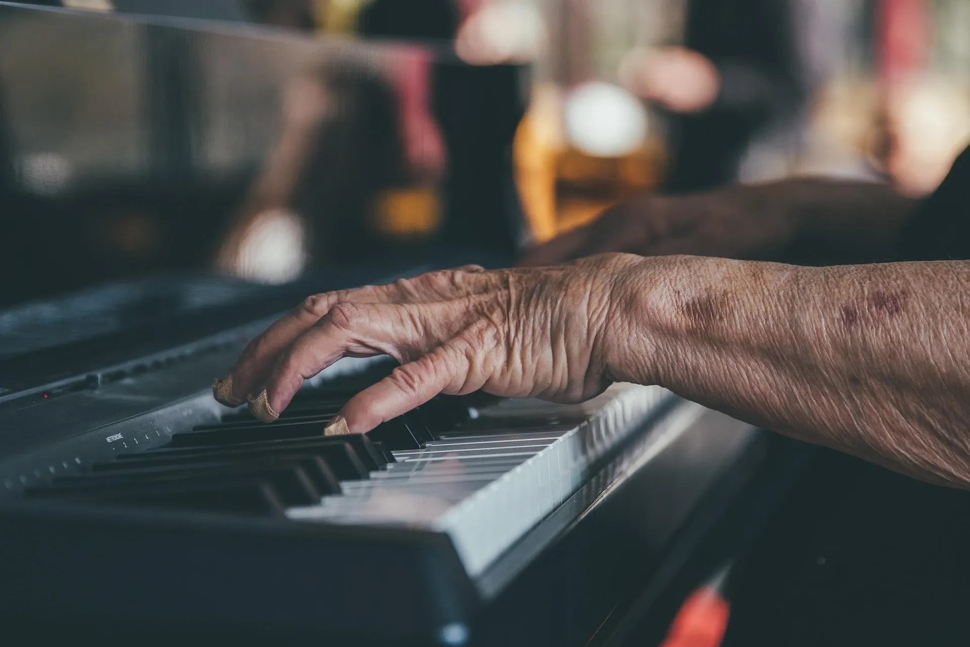 up close of elderly person's hands playing piano