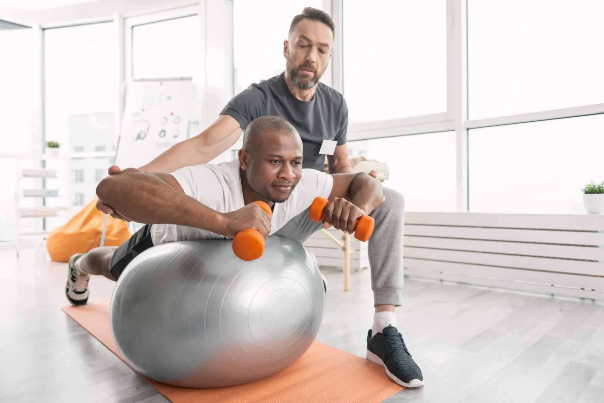 physical therapy with light weights on yoga ball