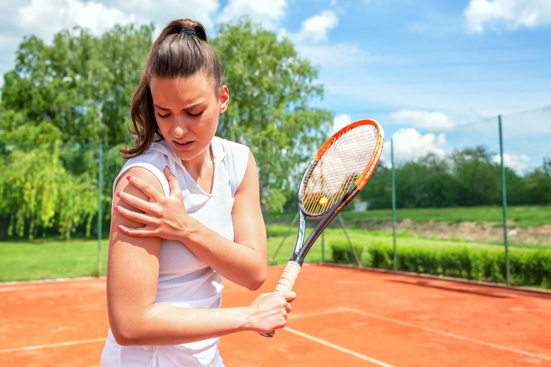 woman playing tennis with shoulder pain