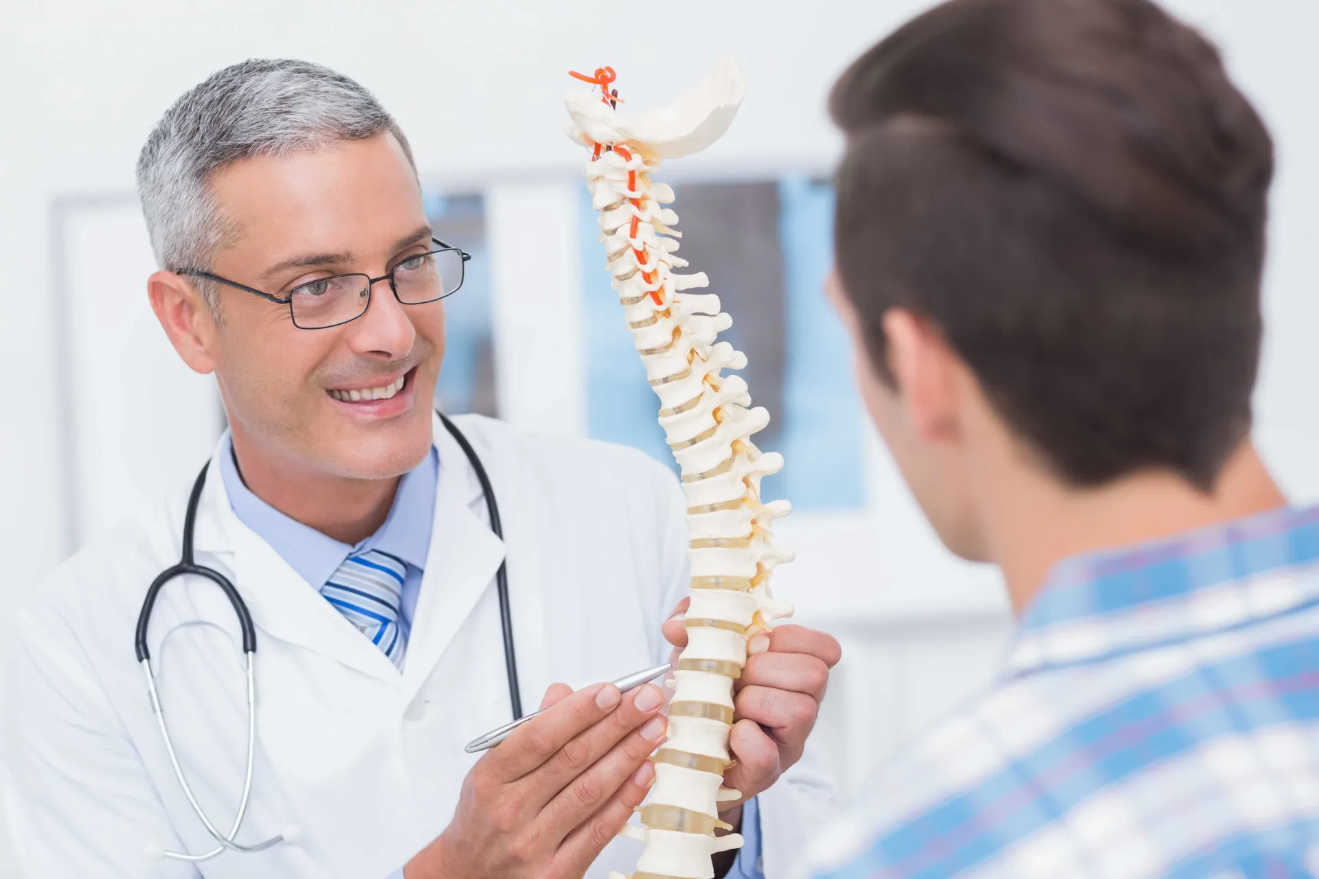 orthopedic doctor explaining spine anatomy to patient